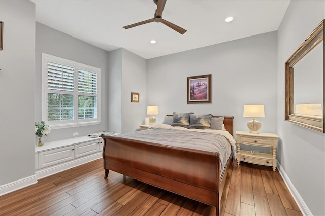 bedroom featuring hardwood / wood-style floors, recessed lighting, a ceiling fan, and baseboards