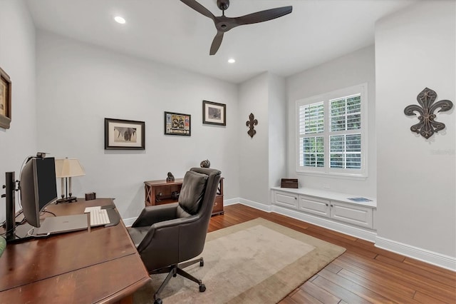 office space featuring recessed lighting, wood-type flooring, ceiling fan, and baseboards