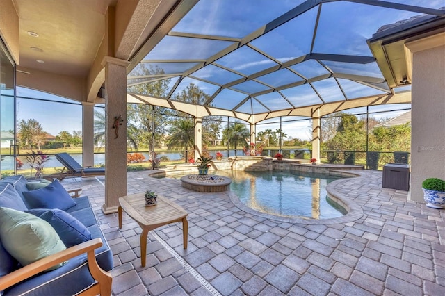 view of patio / terrace with a lanai and a pool with connected hot tub