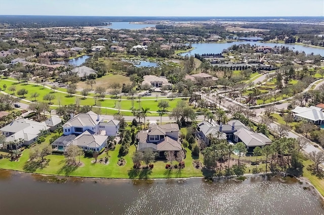 bird's eye view featuring a water view and a residential view