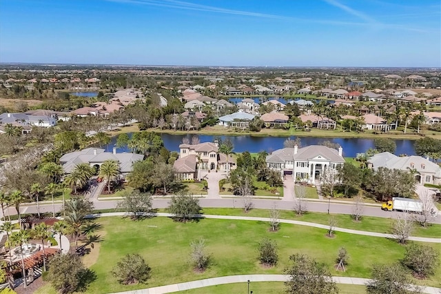 birds eye view of property with a water view and a residential view