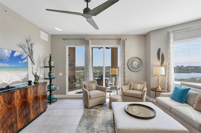 living area with plenty of natural light, visible vents, light tile patterned floors, and ceiling fan