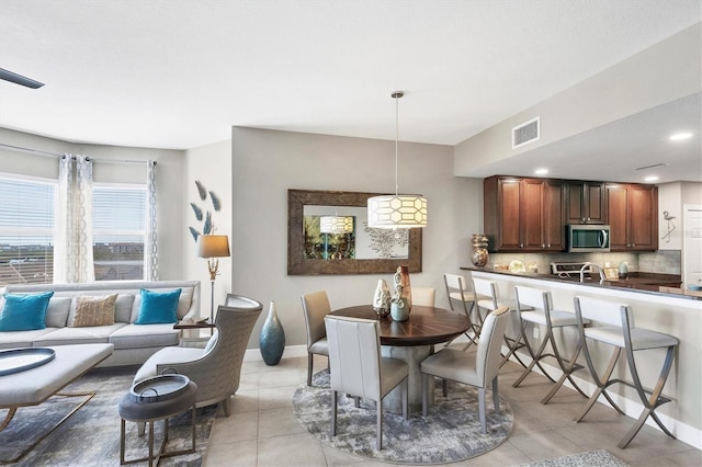 dining room featuring light tile patterned floors, visible vents, baseboards, and recessed lighting