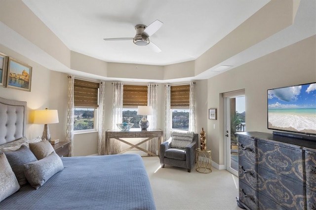 carpeted bedroom featuring baseboards, access to exterior, and a ceiling fan