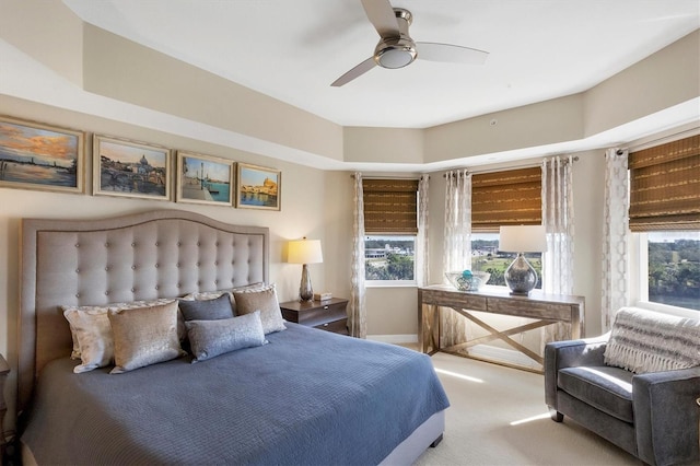 bedroom featuring multiple windows, carpet, and ceiling fan