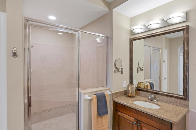 bathroom featuring a stall shower and vanity