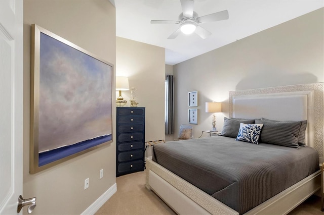 bedroom featuring light carpet, baseboards, and a ceiling fan