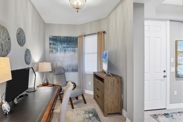 interior space featuring light tile patterned flooring and baseboards