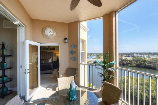 balcony with visible vents and a water view