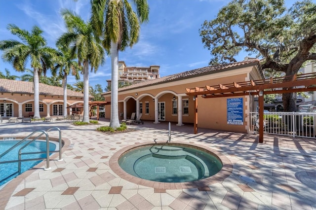 pool featuring a patio area, french doors, and a hot tub