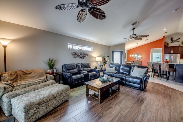 living room with ceiling fan, wood-type flooring, and lofted ceiling