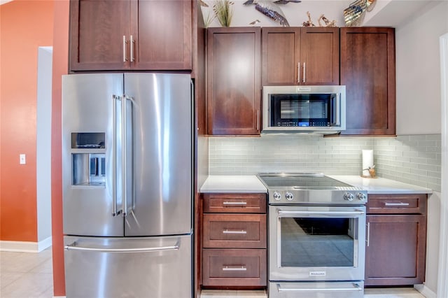 kitchen with backsplash, light tile patterned floors, and stainless steel appliances