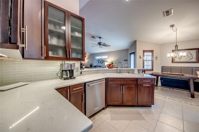 kitchen featuring ceiling fan with notable chandelier, pendant lighting, sink, backsplash, and stainless steel dishwasher