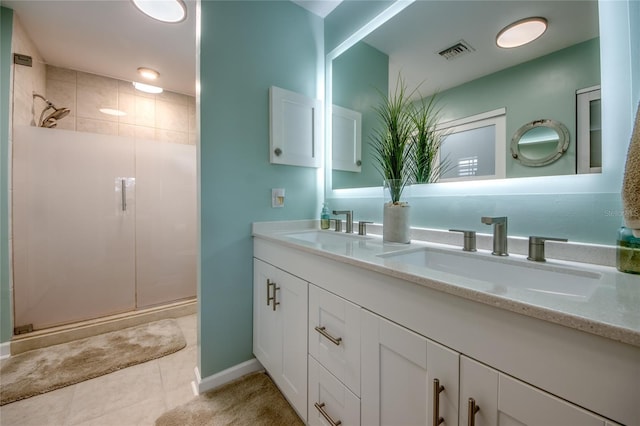 bathroom with an enclosed shower, vanity, and tile patterned flooring