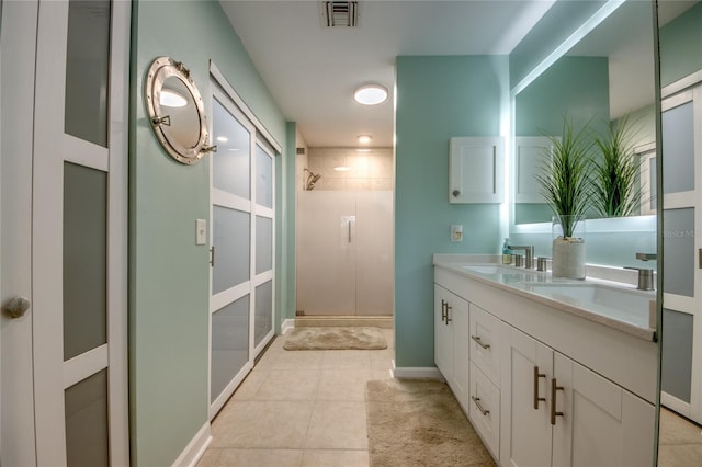 bathroom with vanity, tile patterned floors, and a shower with shower door