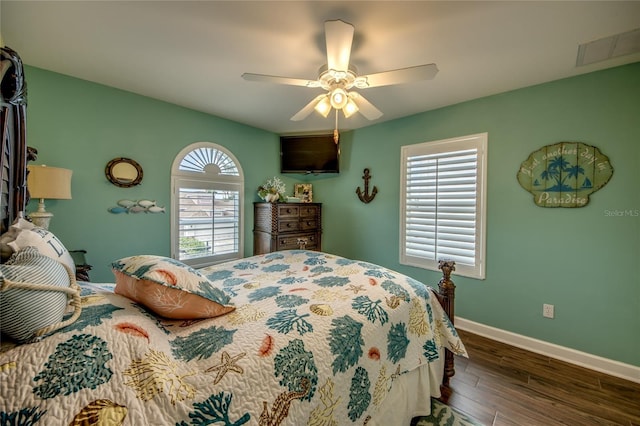 bedroom with dark hardwood / wood-style floors and ceiling fan