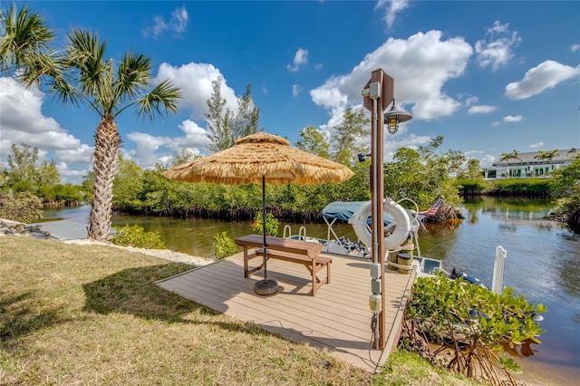 view of dock featuring a yard and a water view