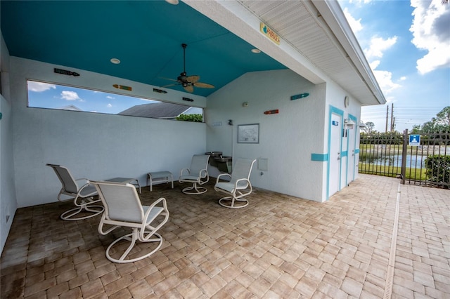 view of patio / terrace with a water view and ceiling fan