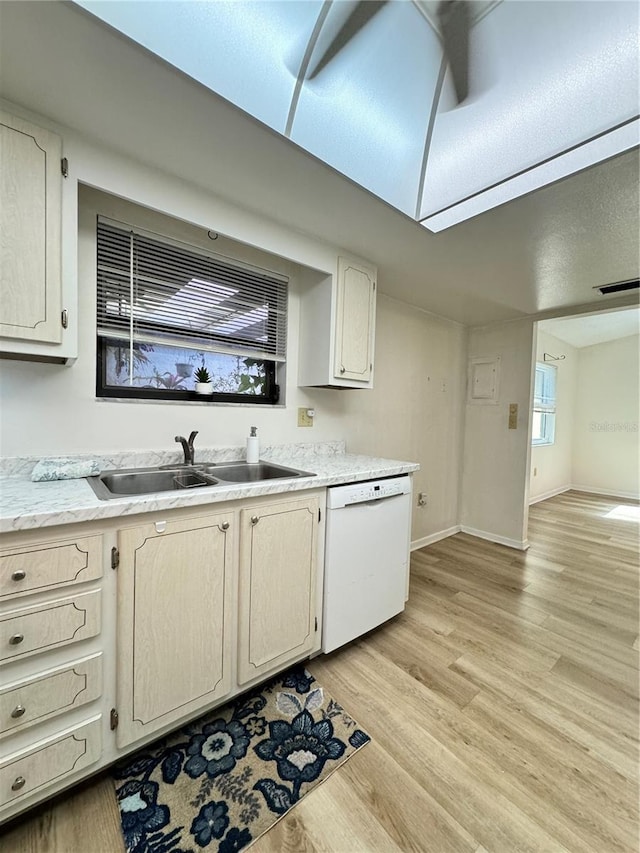 kitchen featuring white dishwasher, sink, and light hardwood / wood-style floors