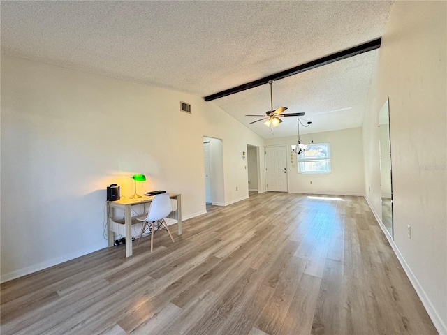 unfurnished living room featuring ceiling fan with notable chandelier, light hardwood / wood-style floors, lofted ceiling with beams, and a textured ceiling