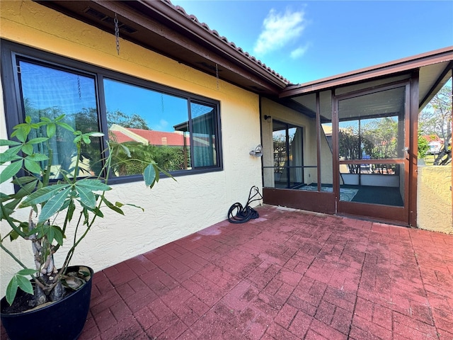 view of patio / terrace featuring a sunroom