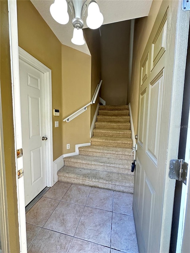 stairs featuring tile patterned floors