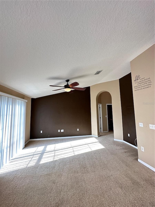 carpeted empty room featuring a textured ceiling and ceiling fan