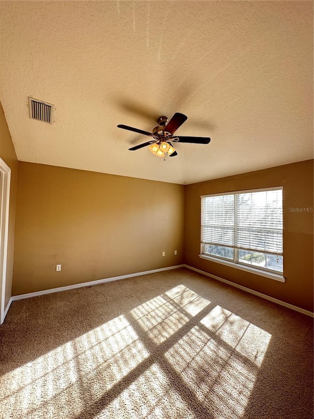 unfurnished room featuring carpet floors, a textured ceiling, and ceiling fan