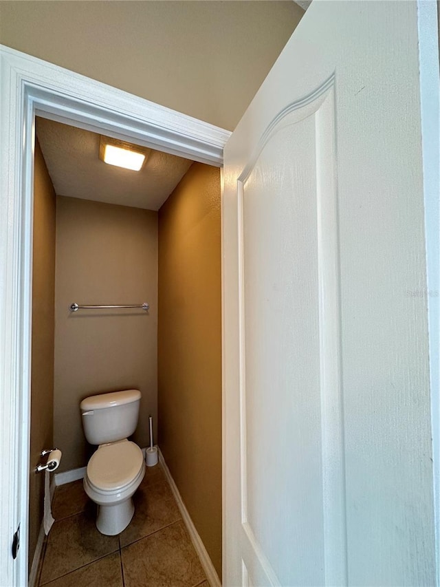 bathroom with tile patterned flooring and toilet