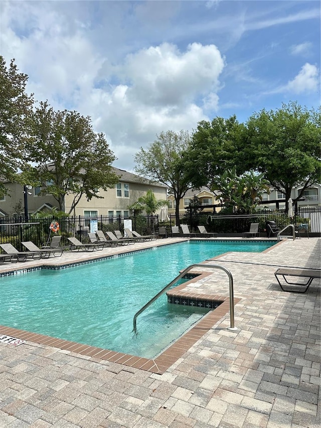 pool featuring a patio and fence