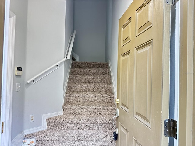 staircase featuring baseboards