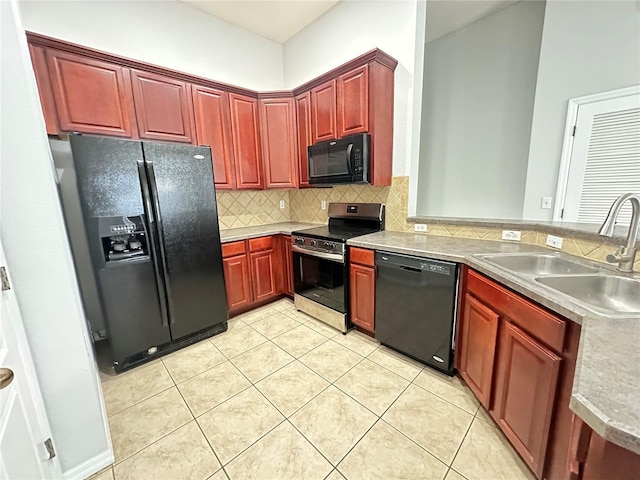 kitchen featuring light tile patterned floors, a sink, decorative backsplash, black appliances, and reddish brown cabinets