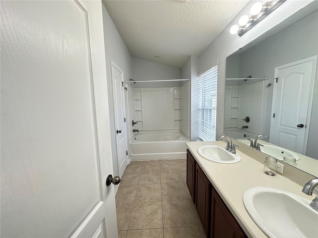 full bathroom featuring a textured ceiling, bathtub / shower combination, and a sink