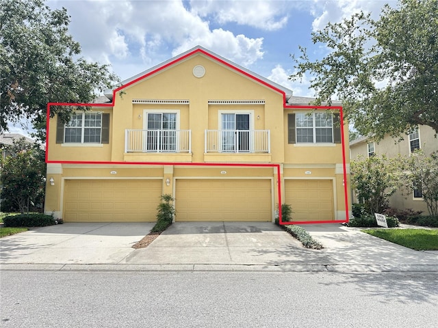 6768 Breezy Palm Dr, Riverview, FL 33578 - townhome / multi-family property featuring driveway, a garage, stucco siding, and a balcony
