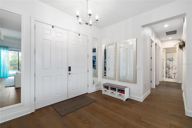 mudroom featuring dark hardwood / wood-style flooring and an inviting chandelier