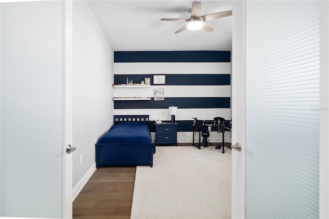 sitting room with hardwood / wood-style floors and ceiling fan