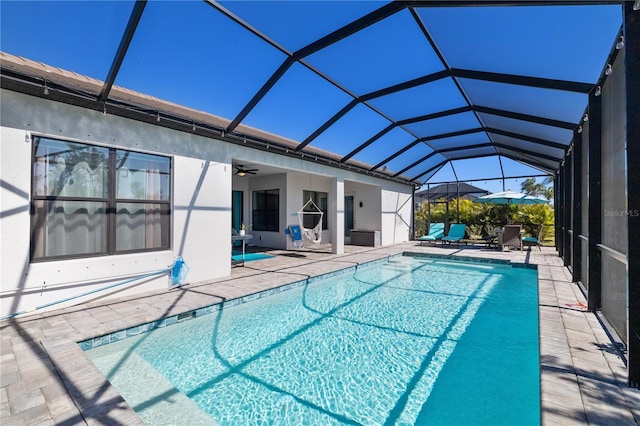 view of pool featuring a lanai, a patio area, and ceiling fan