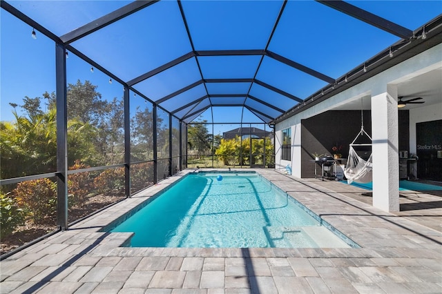 view of pool featuring ceiling fan, a lanai, and a patio