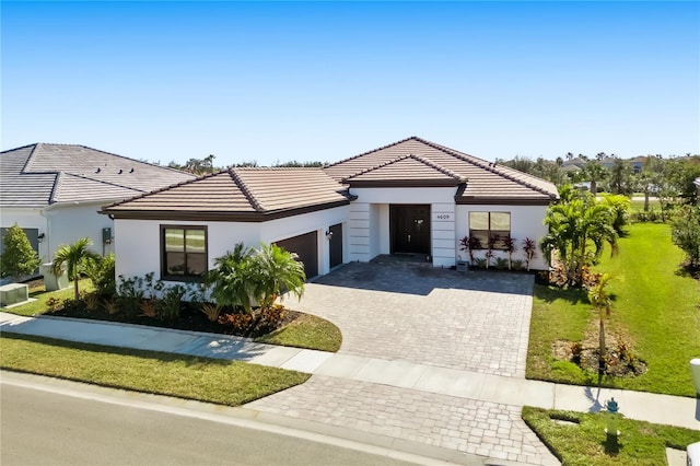 view of front of home with a garage and a front yard