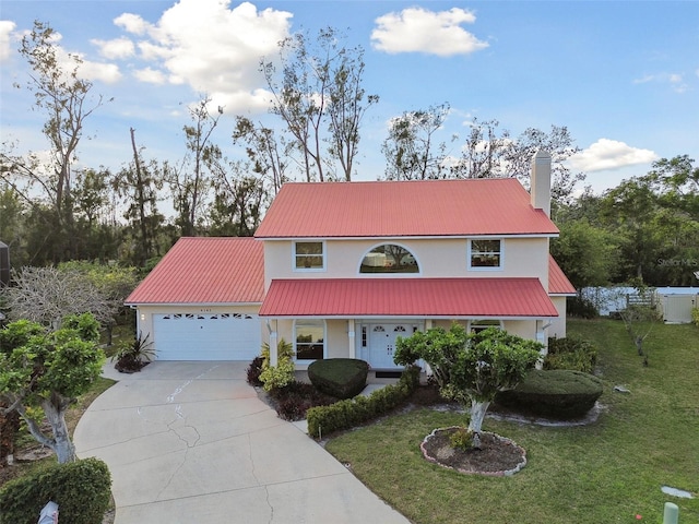 view of front of property with a front lawn and a garage