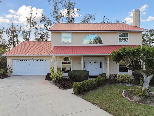 view of front of home featuring a front lawn and a garage