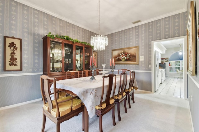 carpeted dining space with an inviting chandelier