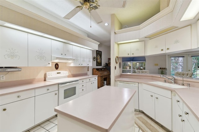 kitchen with white cabinetry, white appliances, kitchen peninsula, a kitchen island, and sink