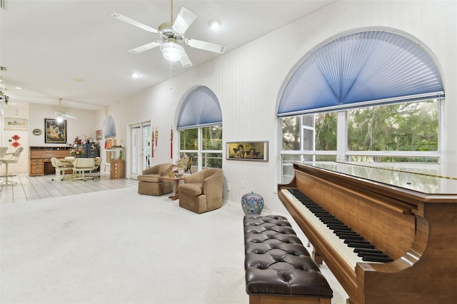 living area featuring ceiling fan and carpet floors