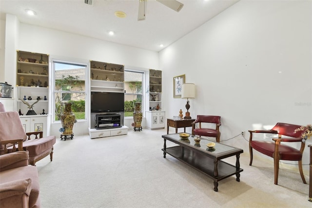 living room with ceiling fan and light carpet