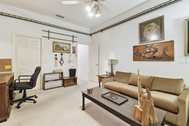 living room with light colored carpet, a textured ceiling, and ceiling fan