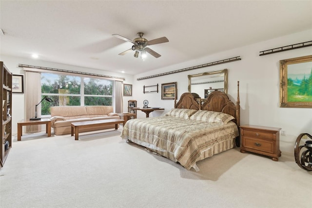 bedroom featuring light colored carpet and ceiling fan