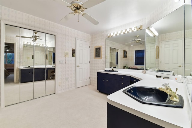 bathroom featuring ceiling fan and vanity