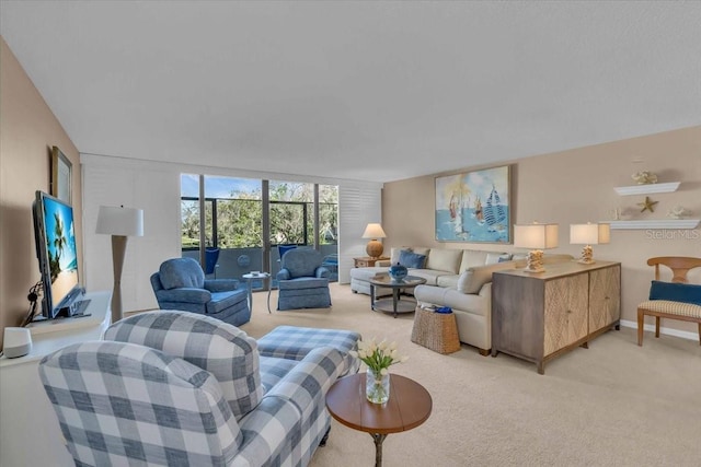 carpeted living room featuring floor to ceiling windows