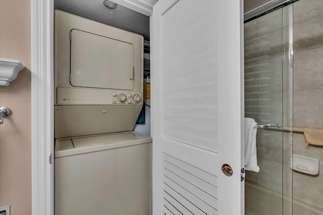 clothes washing area with stacked washer / drying machine